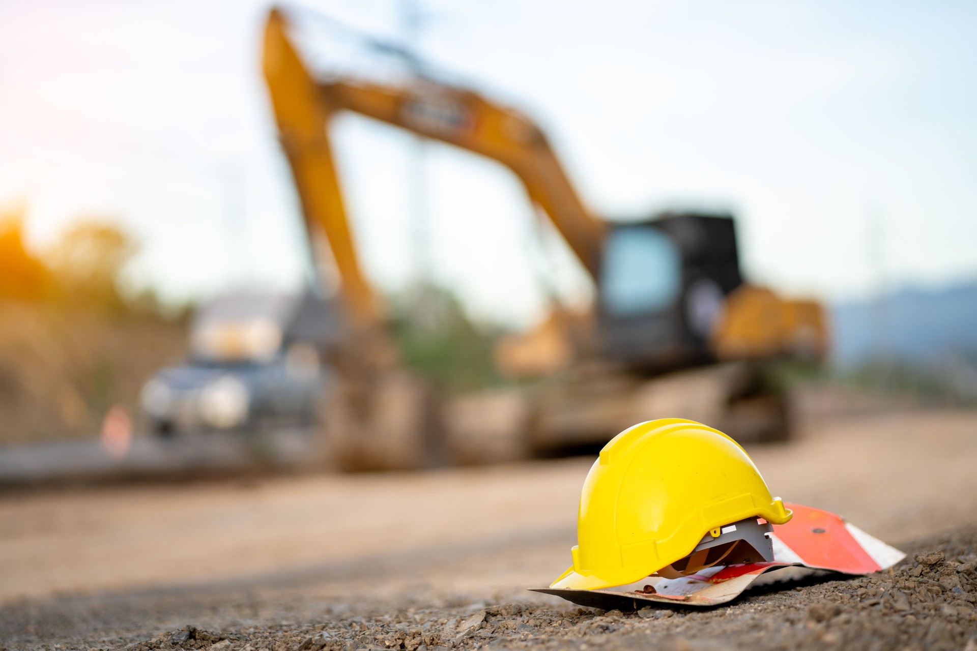 Safety helmets at construction site, road construction site background, safety concept